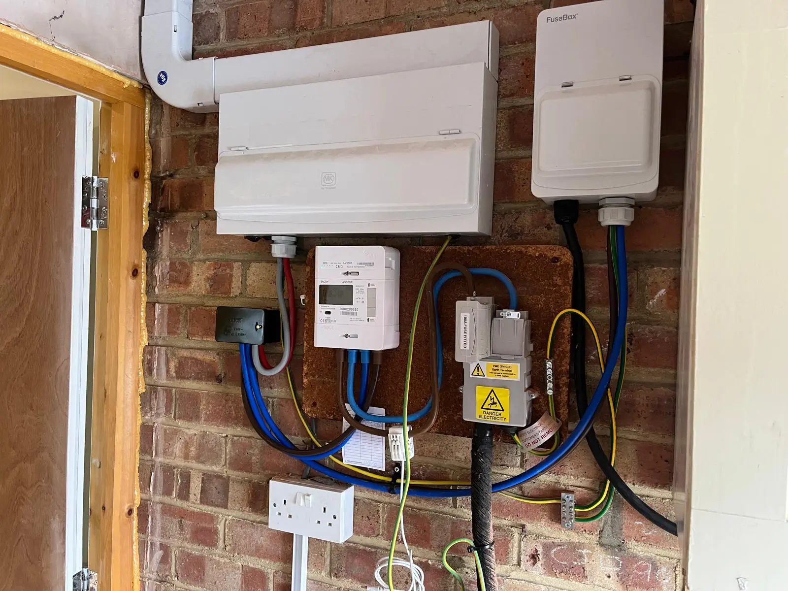 Electrician from Bring it Ohm Electrical Solutions carrying out fault finding at a house near Claygate